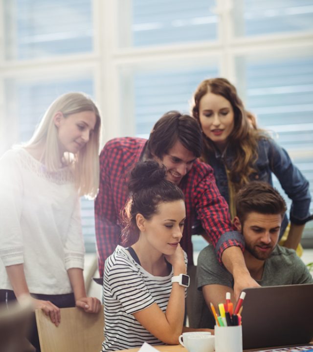 group-business-executives-discussing-laptop-their-des